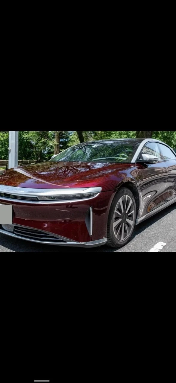 Front-left three-quarter view of the burgundy 2022 Lucid Air Grand Touring.