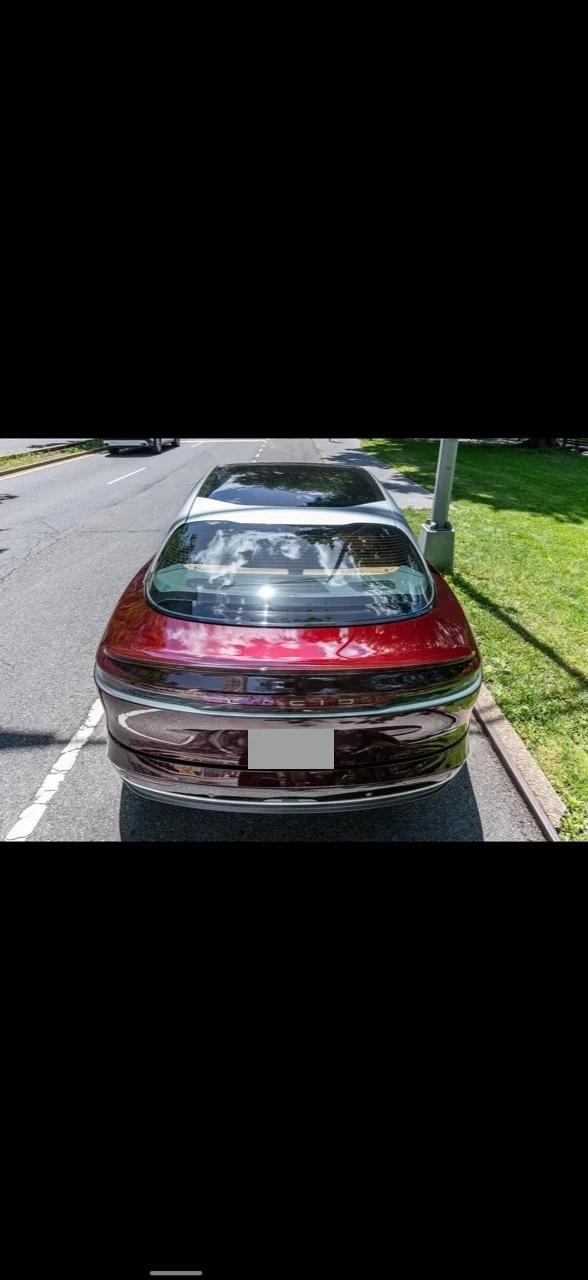 Elevated rear view of the burgundy 2022 Lucid Air Grand Touring.